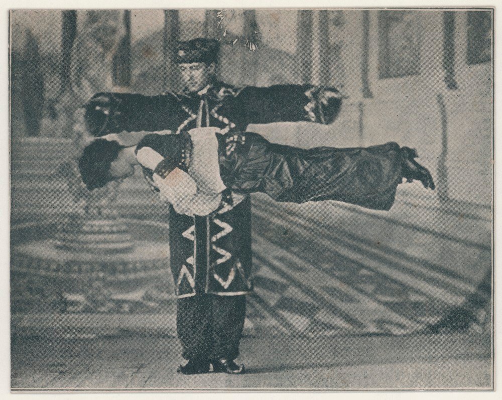 an vintage early photograph of Thurston the Famous magician suspending a women in mid-air by magic.